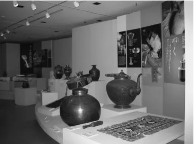 Figure 12  At the “beating” corner, bark-cloth, large containers, steel drum, and  stone mallet are exhibited.