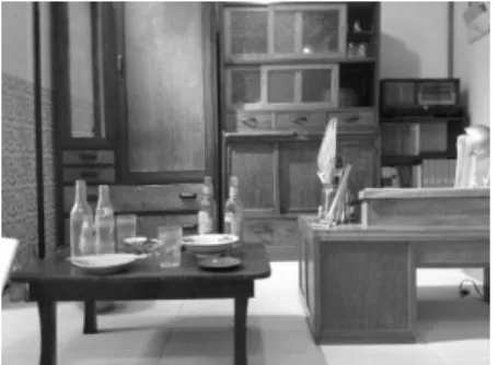 Figure 11: The replica of the room in which the  famous cartoonists lived. There are some alcohol  containers on the table