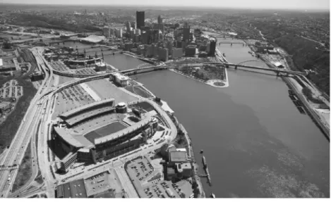 Figure 1.1  Aerial view of Pittsburgh, Pennsylvania. The North Shore (foreground) includes concen- concen-trated investments in the development of the Carnegie Science Center and the UPMC Sports Works,  Heinz Field, PNC Park, the Children’s Museum, the And