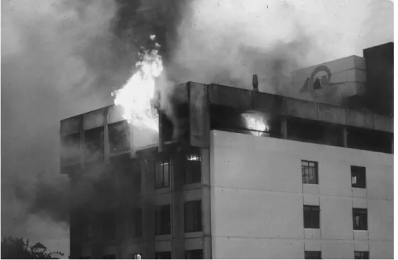 Figure 3.8  Post‐flashover fire on the top floor of a multi‐storey office building. The flames coming out  of the windows indicate that this fire is ventilation controlled
