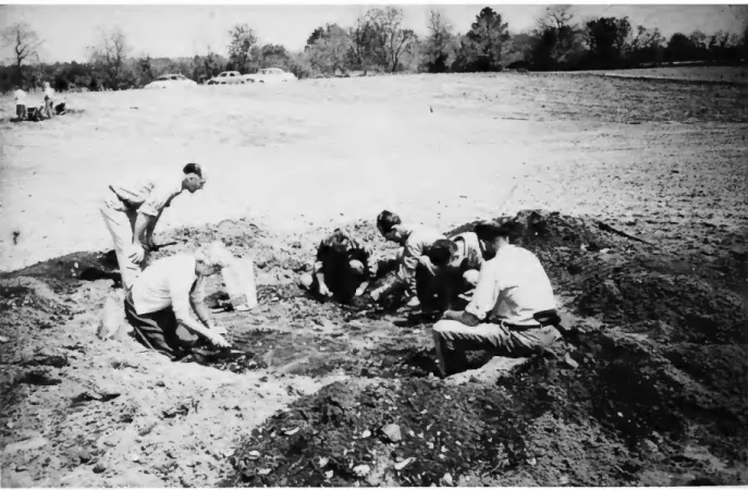 FIGURE 2.—Waldo looking on as members and guests of the Sussex County Archeological  Society excavate a pit in the vicinity of Rehoboth, Delaware, ca