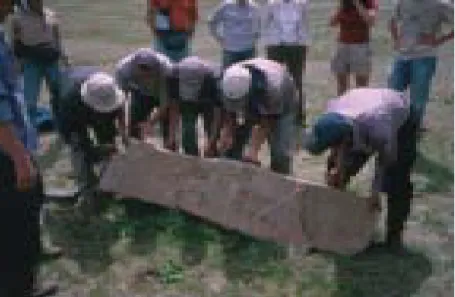 Figure 10: Scanning team - working on Evdei Deer Stone 1 in make shift tent to control light.