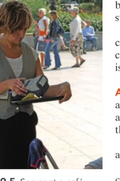 Figure 9.5 Server at a café uses a mobile scanner to process customers’ credit card payment.