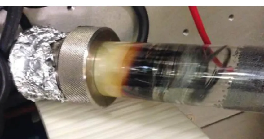 Figure 3.2: Picture of SiGe growth tube, showing germanium species present on the upstream cold zone of the tube (to the left of the clear section).