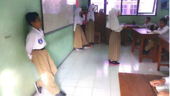 Gambar 1. Siswa yang datang terlambat berdiri di depan kelas  untuk berdoa 