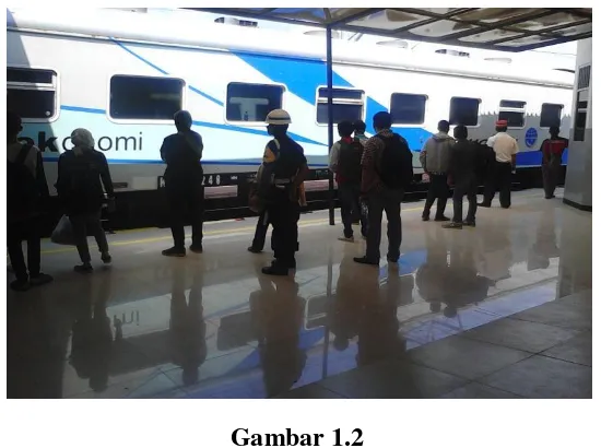 Gambar 1.2 PKD menjaga penumpang yang akan turun dan naik kereta 