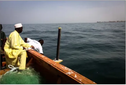 Figure  3.  Dawda Saine and Ousman Bojang of NASCOM deploy the first spar buoy at Bakau