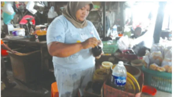 Foto 3.8. Ibu Airiah sedang menyeduh jamu  pesanan salah seorang pembeli.