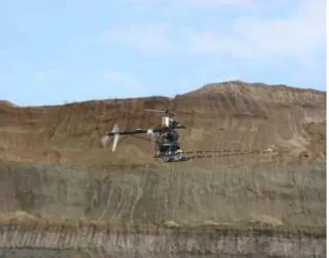Figure  gmbh, Switzerland) operating in an open pit coal field, Turkey. The magnetometer is mounted on a stinger in front of the UAS