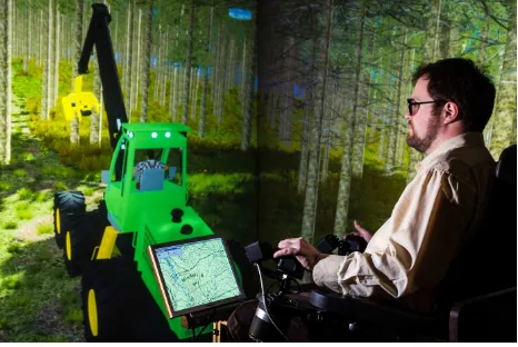 Figure 1. A driver training with the forest machine simulator 