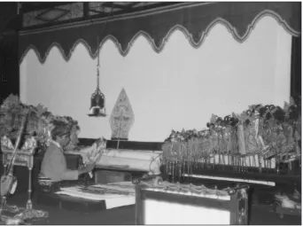 Figure 1. A screen before performance. The puppeteer readying the puppets is the late Ki Ronosuripto