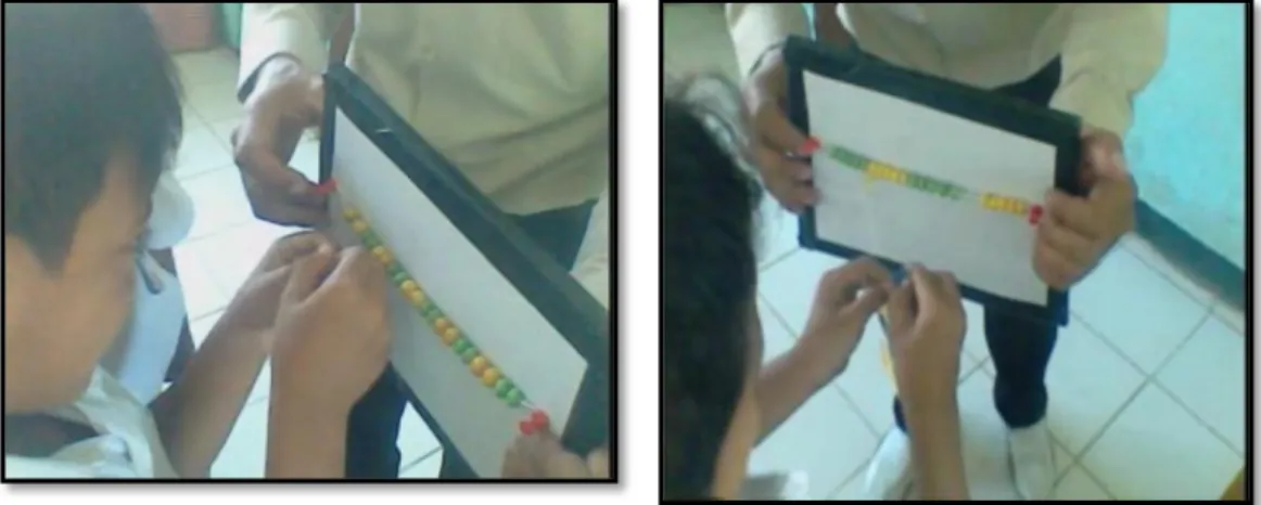 Gambar i  :  Siswa  sedang  berhitung  dan  memasang  kartu  bilangan  pada  manik-manik  warna sama 