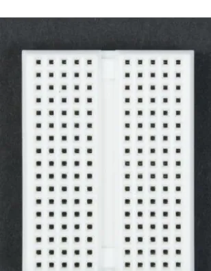 Figure 3-5. View of the bottom of the prototyping breadboard; metal plates conduct current from hole to hole