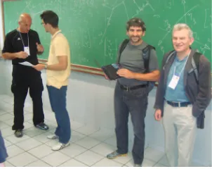 Figure 2. From left, Dimiter Zlatanov, Brazilian student Henrique Prado, and lecturers Harvey Lipkin and Jon Selig discussing the material at the end of a long school day.