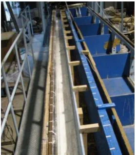 Figure 2 The experiment setup, where a) water tank, b) pump, c) rigid bed,  