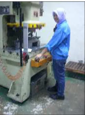 Figure 1.1: A machine operator is exposed to WBV during metal stamping process. 