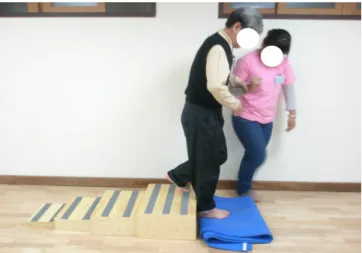 Figure 4. Holding and throwing a small object while balancing on an exercise ball