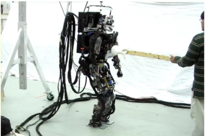 Fig.    1. A photograph of the SARCOS hydraulic biped humanoid. 