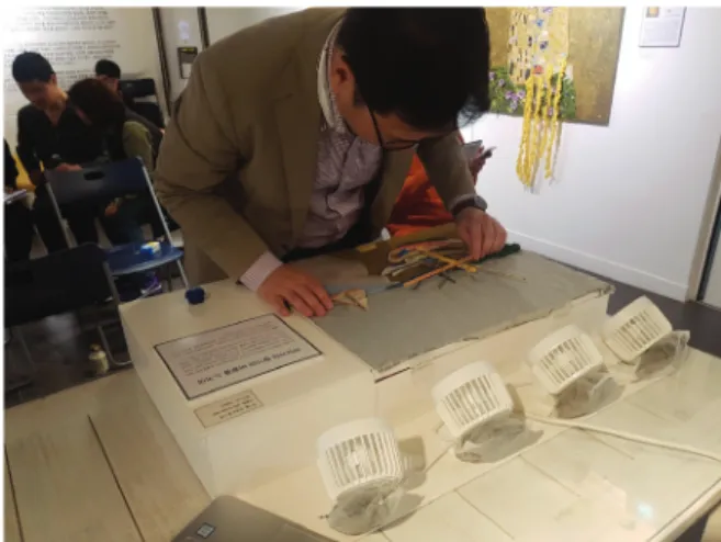 Fig. 4. A participant with visual impairment is appreciating  the artwork with multisensory interaction techniques.