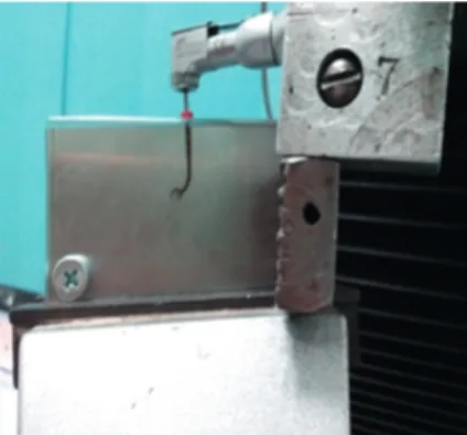 Figure 1. File attached to the contra-angled hand piece and inserted within the simulated canal, fixed to the lower  compartment of the testing machine.
