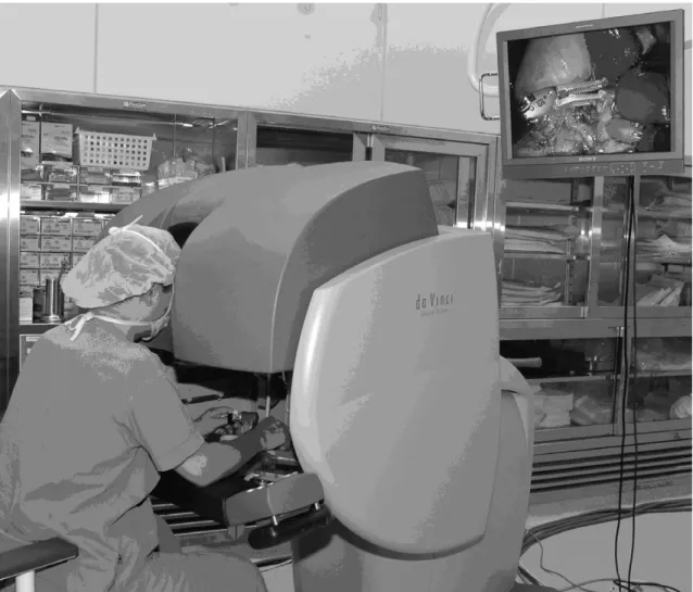Figure 3. Surgeon at the console and the robotic operating room.