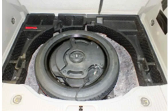 Fig. 2 Spare tire with sub woofer speak at rear floor panel