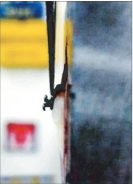 Figure 1. Shear bond strength test with the Instron  machine showing where the debonding force was applied