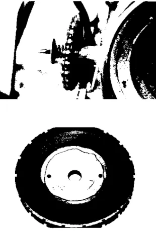 Figure 2.—(Top). Spring-mounted driven sprocket disengaged from the  hopper axle so the seed plate can be turned to position seed over the drop  tube