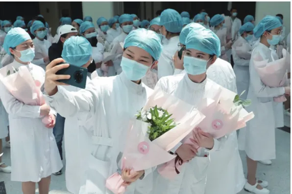 Figure 5. Nurses Wearing Face Masks Pose for Pictures During an Event Held to Mark International Nurses Day, at Wuhan Tongji Hospital