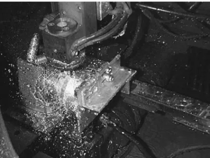 Fig. 2. WEDM machine of water flushing type to slice silicon ingot with fixture used.