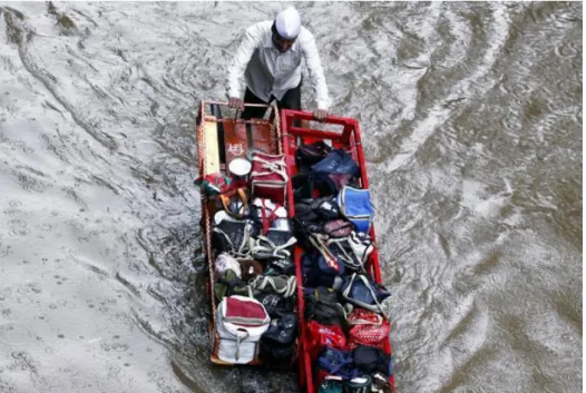 Figure 2.1: Dabbawala delivering lunch boxes during rain.           