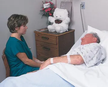 FIGURE 5-3 Communication with the elder with a vision or hearing  deficit. Sit in front of the patient where your lips can be seen to  communicate