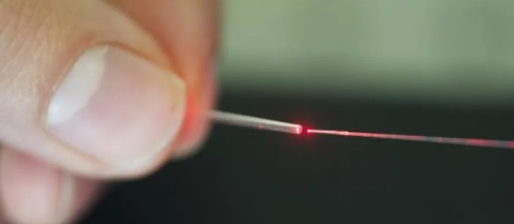Figure 5. OFPS (right) illuminated in red and placed into a miniaturized catheter (left).
