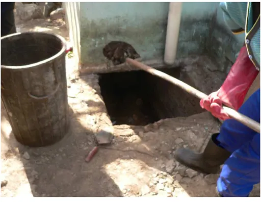 Figure 2-5 Manual emptying a VIP latrine using a shovel 