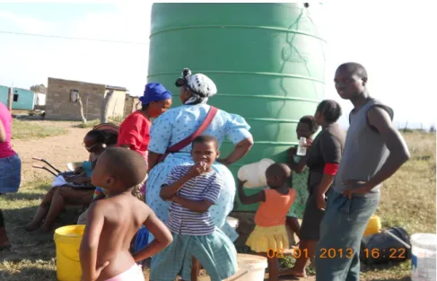 Figure 6: Researcher observing community at a water point. 