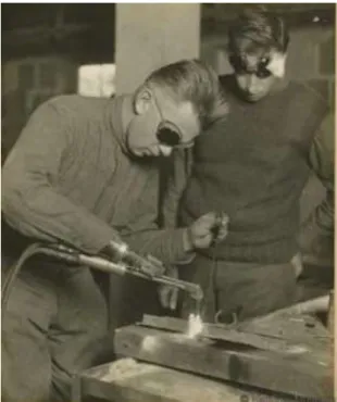 Figure  1-2  shows  an  amputee  using  a  prosthesis  and  being  able  to  weld  with  it