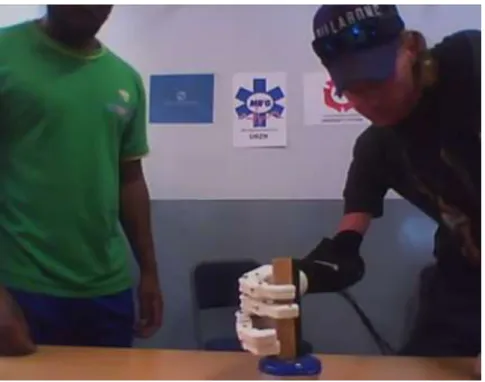 Figure 2-23 shows the amputee preparing to position the chalk duster on the plastic container