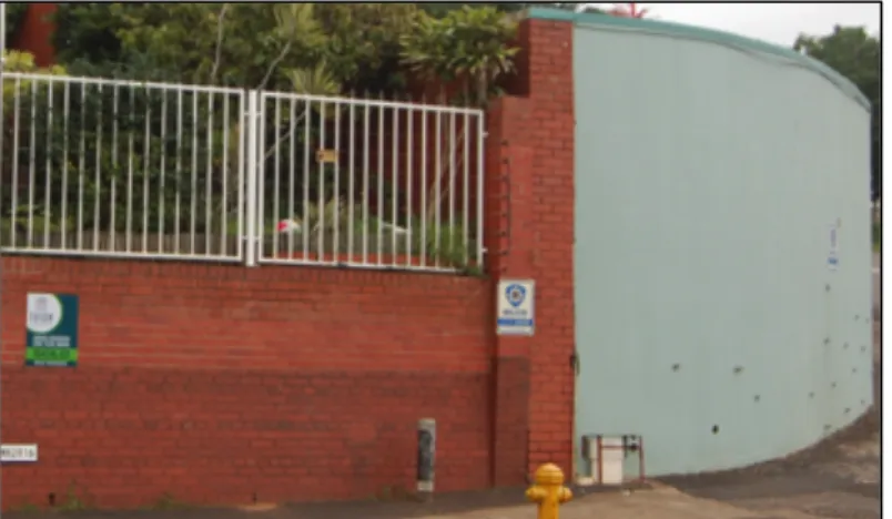 Figure  11:  This  photo  provides  a  good  contrast.  On  the  left  is  a  house  with  high  walls  but  one  that  has  a  degree  of  visibility  because of the white see-through fencing, in  direct contrast to the very high grey wall with  no visibi